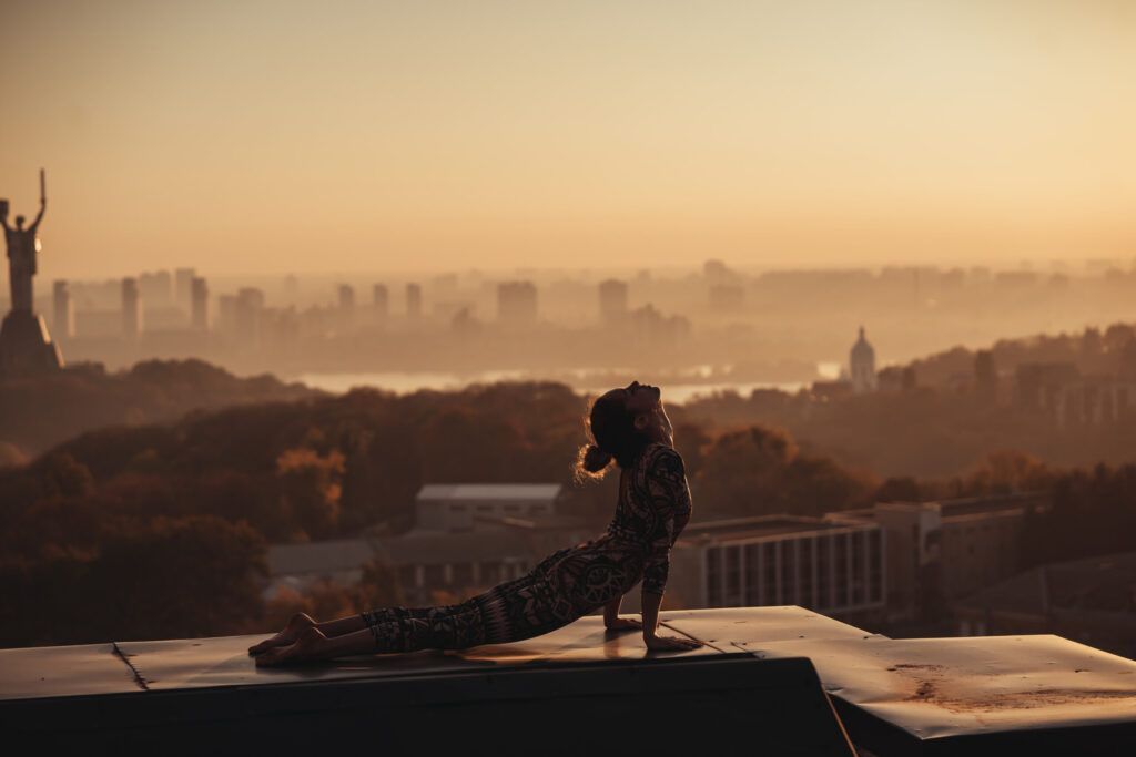 Woman doing yoga on roof